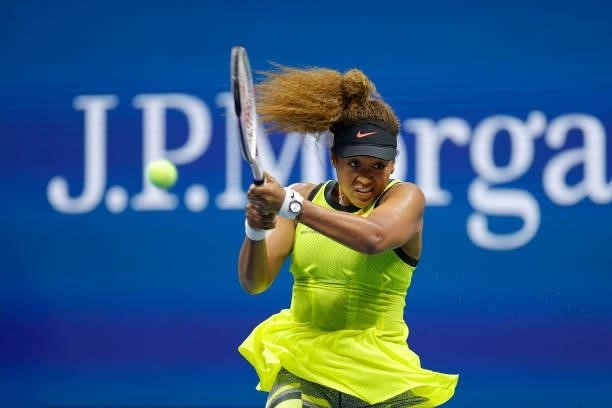 Naomi Osaka of Japan returns a shot against Marie Bouzkova of Czech Republic during their women's singles first round match on Day One of the 2021 US...
