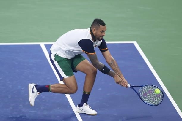 Nick Kyrgios of Australia returns the ball against Roberto Bautista Agut of Spain during their Men's Singles first round match on Day One of the 2021...