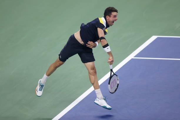 Roberto Bautista Agut of Spain serves the ball against Nick Kyrgios of Australia during their Men's Singles first round match on Day One of the 2021...