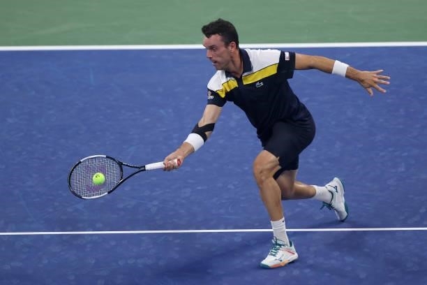 Roberto Bautista Agut of Spain returns the ball against Nick Kyrgios of Australia during their Men's Singles first round match on Day One of the 2021...
