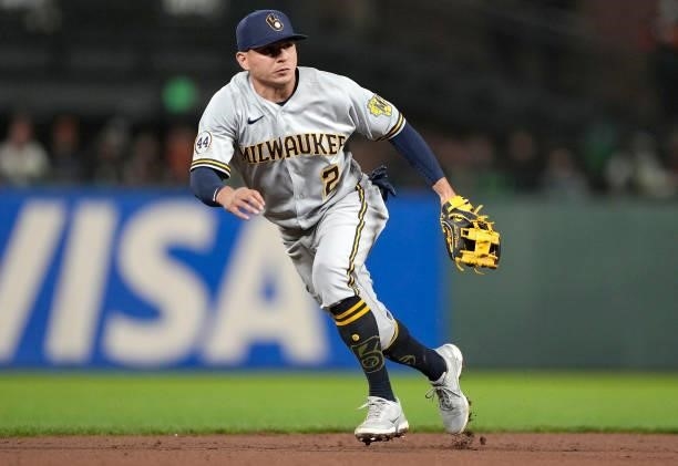 Luis Urias of the Milwaukee Brewers reacts to a ground ball off the bat of Wilmer Flores of the San Francisco Giants in the bottom of the six inning...