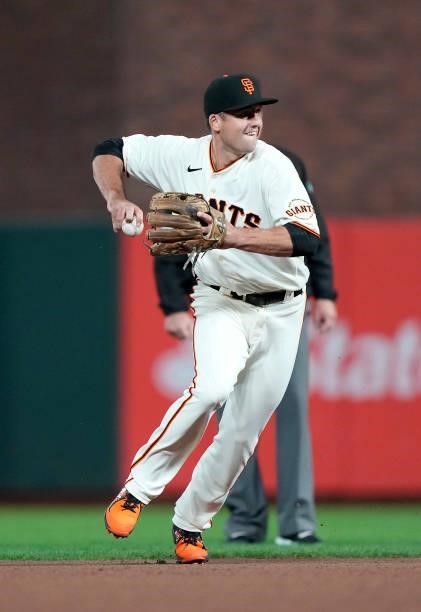 Jason Vosler of the San Francisco Giants looks to throw to first base against the Milwaukee Brewers in the top of the six inning at Oracle Park on...
