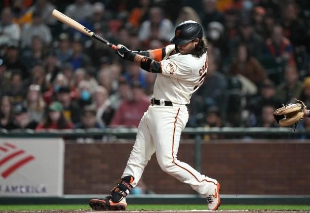 Brandon Crawford of the San Francisco Giants hits an RBI single scoring Brandon Belt against the Milwaukee Brewers in the bottom of the seventh...