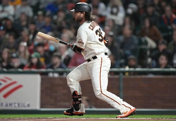 Brandon Crawford of the San Francisco Giants hits an RBI single scoring Brandon Belt against the Milwaukee Brewers in the bottom of the seventh...