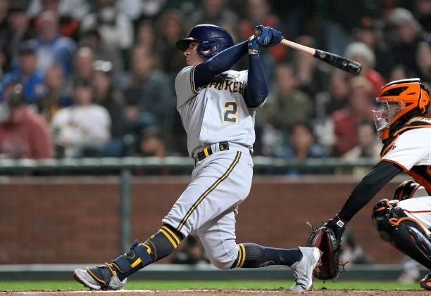 Luis Urias of the Milwaukee Brewers hits a sacrifice fly scoring Omar Narvaez against the San Francisco Giants in the top of the eighth inning at...