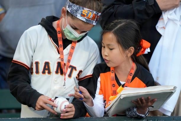San Francisco Giants fans seeking autographs from players prior to the start of the game against the Milwaukee Brewers at Oracle Park on August 30,...