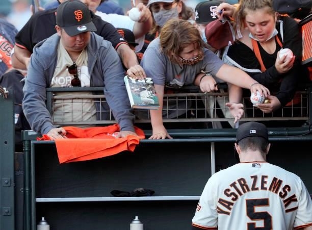 Mike Yastrzemski of the San Francisco Giants signing autographs for fans prior to the start of the game against the Milwaukee Brewers at Oracle Park...