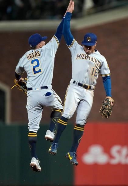 Luis Urias and Kolten Wong of the Milwaukee Brewers celebrates defeating the San Francisco Giants 3-1 at Oracle Park on August 30, 2021 in San...
