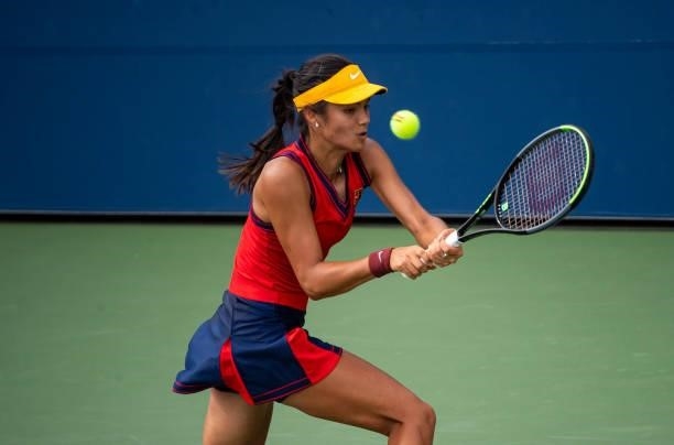 Emma Raducanu of Great Britain chits a backhand against Stephanie Voegele of Switzerland in the first round of the women's singles of the US Open at...