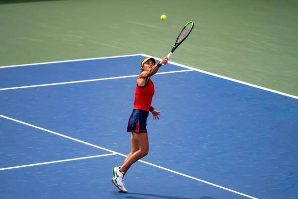 Emma Raducanu of Great Britain chits a backhand against Stephanie Voegele of Switzerland in the first round of the women's singles of the US Open at...