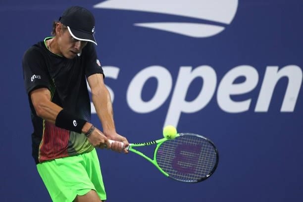 Alex de Minaur of Australia returns the ball against Taylor Fritz of the United States during his Men's Singles first round match on Day Two of the...