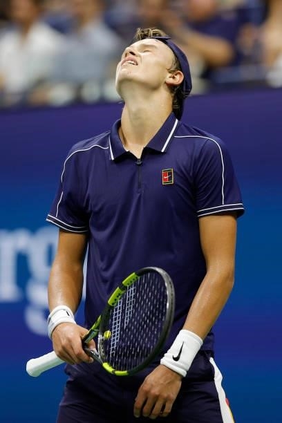 Holger Vitus Nodskov Rune of Denmark reacts against Novak Djokovic of Serbia during his Men's Singles first round match on Day Two of the 2021 US...
