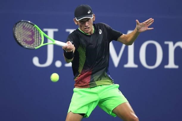 Alex de Minaur of Australia returns the ball against Taylor Fritz of the United States during his Men's Singles first round match on Day Two of the...