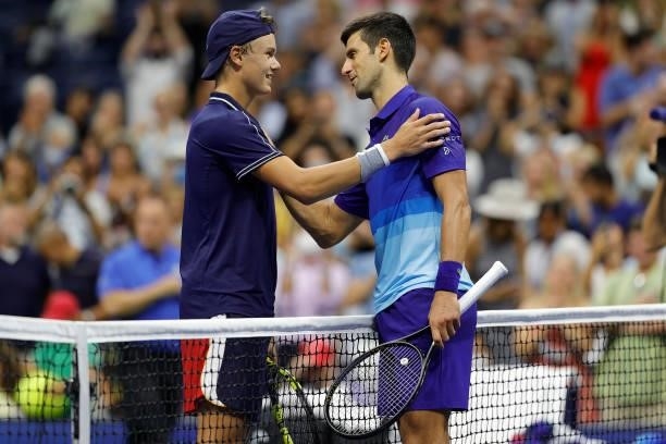 Novak Djokovic of Serbia meets at the net after defeating Holger Vitus Nodskov Rune of Denmark during his Men's Singles first round match on Day Two...