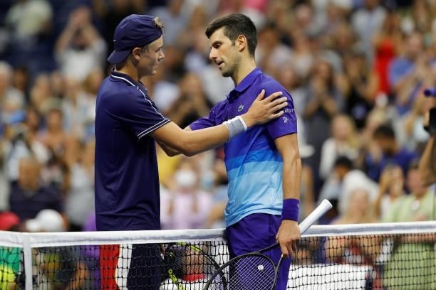 Novak Djokovic of Serbia meets at the net after defeating Holger Vitus Nodskov Rune of Denmark during his Men's Singles first round match on Day Two...