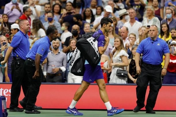 Novak Djokovic of Serbia walks off the court after defeating Holger Vitus Nodskov Rune of Denmark during his Men's Singles first round match on Day...