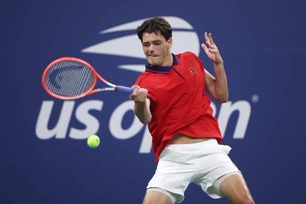 Taylor Fritz of the United States returns the ball against Alex de Minaur of Australia during his Men's Singles first round match on Day Two of the...