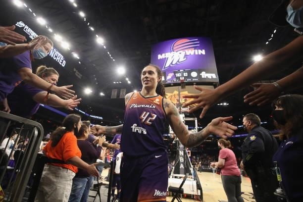 Brittney Griner of the Phoenix Mercury high fives fans following the WNBA game against the Chicago Sky at the Footprint Center on August 31, 2021 in...