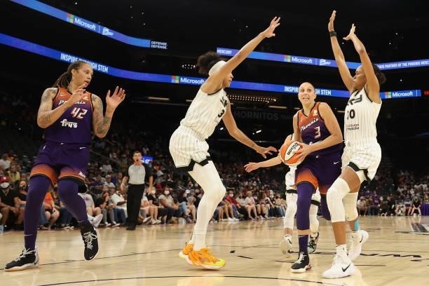 Diana Taurasi of the Phoenix Mercury drives the ball against Candace Parker and Azurá Stevens of the Chicago Sky during the second half of the WNBA...