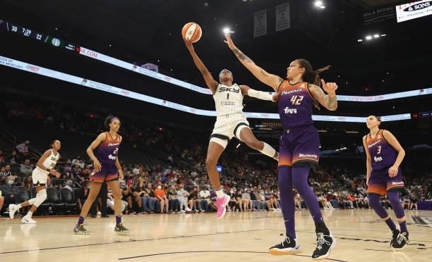 Diamond DeShields of the Chicago Sky attempts a lay-up past Brittney Griner of the Phoenix Mercury during the first half of the WNBA game at the...