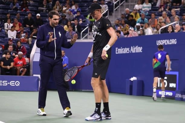 Kevin Anderson of South Africa discusses a wet spot on the court with an umpire during the match against Diego Schwartzman of Argentina during his...