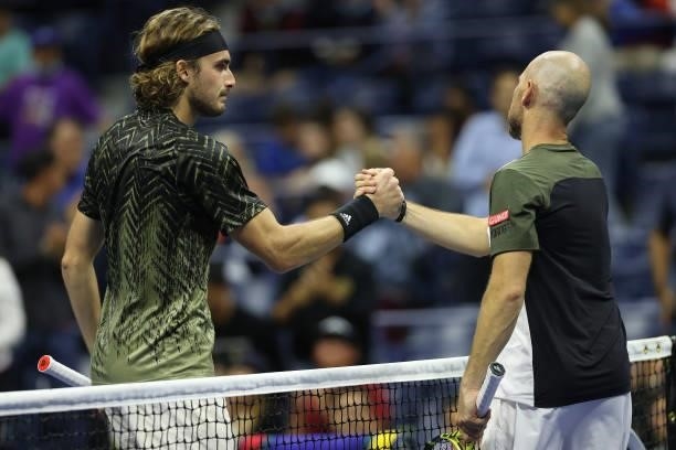 Stefanos Tsitsipas of Greece shakes hands with Adrian Mannarino of France following his Men's Singles second round match win on Day Three of the 2021...