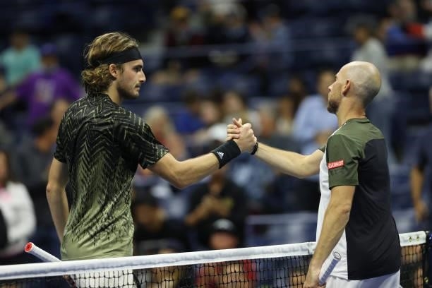 Stefanos Tsitsipas of Greece shakes hands with Adrian Mannarino of France following his Men's Singles second round match win on Day Three of the 2021...
