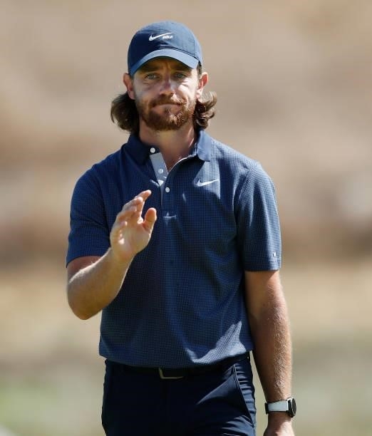 Tommy Fleetwood of England acknowledges the crowd after nearly holing a chip shot on the seventh hole during Day One of The Italian Open at Marco...