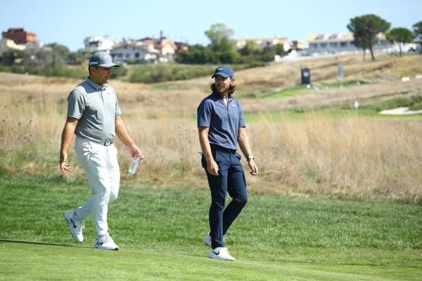 Francesco Molinari of Italy and Tommy Fleetwood of England walk together on the seventh hole during Day One of The Italian Open at Marco Simone Golf...