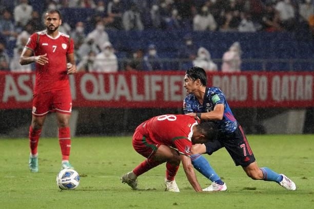 Gaku Shibasaki of Japan and Zahir Sulaiman Al Aghbar of Oman compete for the ball FIFA World Cup Asian Qualifier Final Round Group B match between...