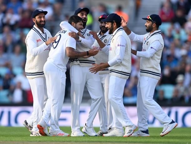 Umesh Yadav of India celebrates with teammates after bowling England captain Joe Root during day one of the Fourth LV= Insurance Test Match between...