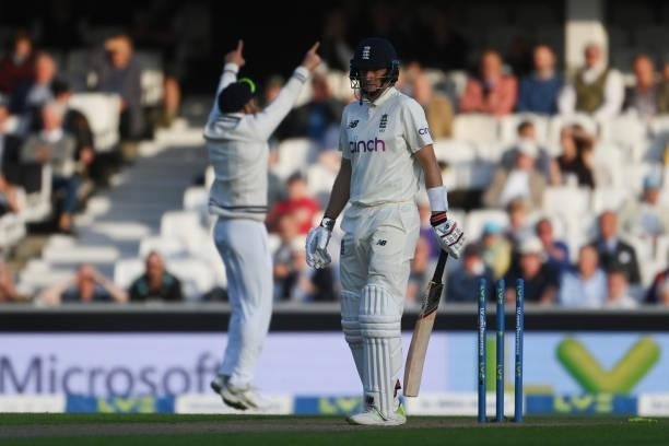 Joe Root of England is bowled by Umesh Yadav of India as Virat Kohli celebrates during the Fourth LV= Insurance Test Match: Day One between England...