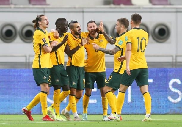 Awer Mabil of Australia celebrates with teammates after scoring their team's first goal during the 2022 FIFA World Cup Qualifier match between...