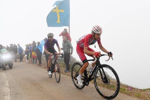 Oscar Cabedo Carda of pain and Team Burgos - BH and Guillaume Martin of France and Team Cofidis compete while fans cheer during the 76th Tour of...
