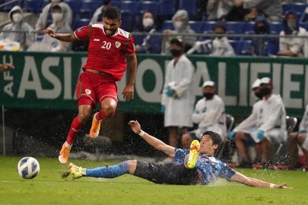 Salaah Said Al Yahyaei of Oman is tackled by Hiroki Sakai of Japan during FIFA World Cup Asian Qualifier Final Round Group B match between Japan and...