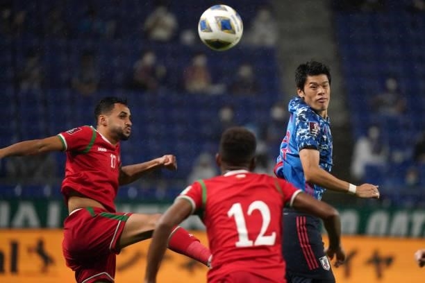 Hiroki Sakai of Japan and Ali Sulaiman Al Busaidi of Oman compete for the ball during FIFA World Cup Asian Qualifier Final Round Group B match...