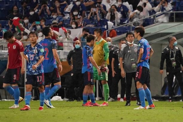 Japan head coach Hajime Morimoto and his players show dejection after FIFA World Cup Asian Qualifier Final Round Group B match between Japan and Oman...