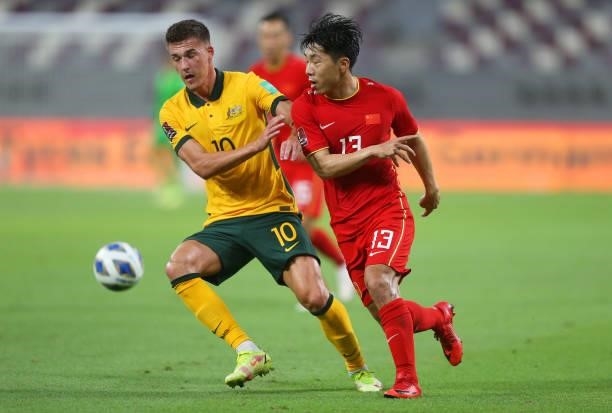 Ajdin Hrustic of Australia and Jin Jingdao of China PR battle for the ball during the 2022 FIFA World Cup Qualifier match between Australia and China...