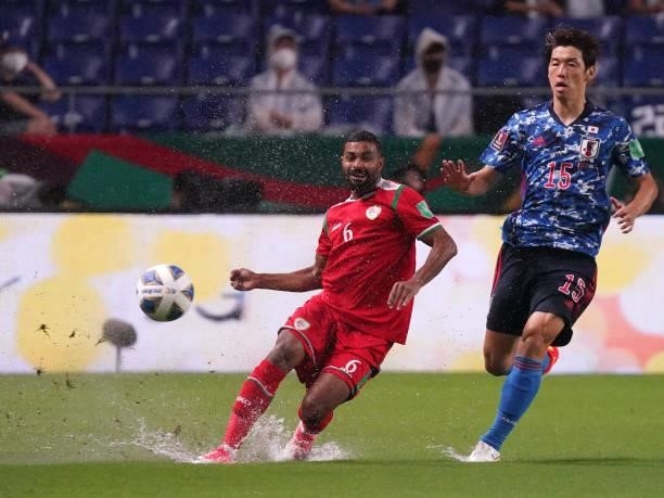 Ahmed Al Khamisi of Oman in action under pressure from Yuya Osako of Japan during FIFA World Cup Asian Qualifier Final Round Group B match between...