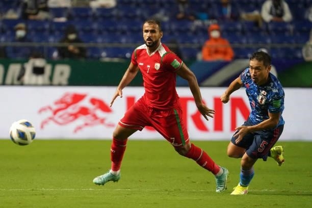 Yuto Nagatomo of Japan and Khalid Khalifa Al Hajri of Oman compete for the ball during FIFA World Cup Asian Qualifier Final Round Group B match...