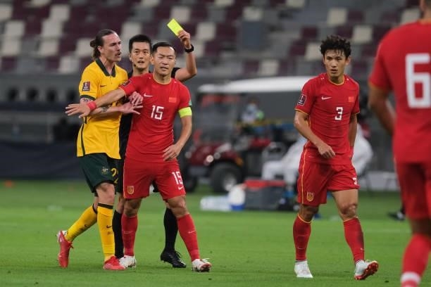 Wang Shenchao receives a yellow card after fouling Martin Boyle during Australia v China PR - 2022 FIFA World Cup Qualifier at Khalifa International...