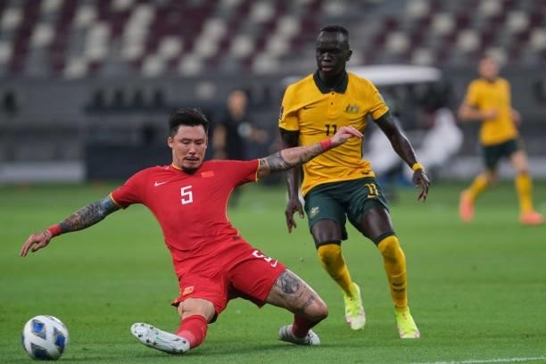 Zhang Linpeng tackles Awer Mabil during Australia v China PR - 2022 FIFA World Cup Qualifier at Khalifa International Stadium on September 02, 2021...