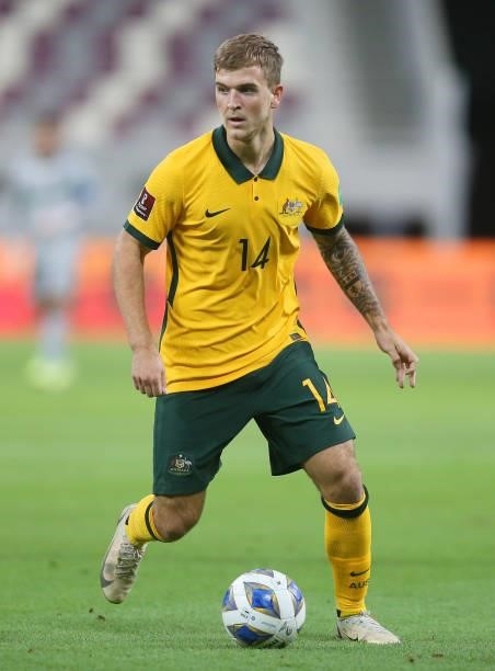 Riley McGree of Australia runs with the ball during the 2022 FIFA World Cup Qualifier match between Australia and China PR at Khalifa International...