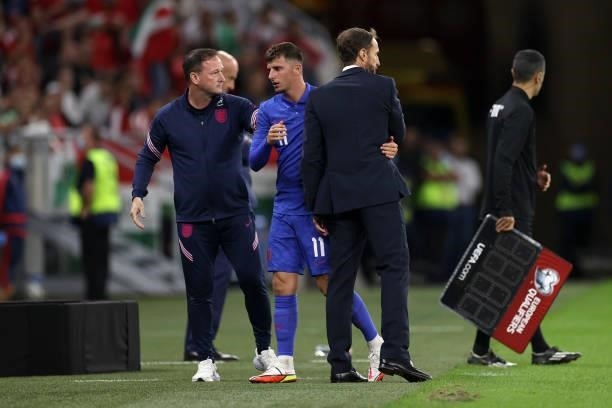 Gareth Southgate, Head Coach of England interacts with Mason Mount as he is substituted during the 2022 FIFA World Cup Qualifier match between...