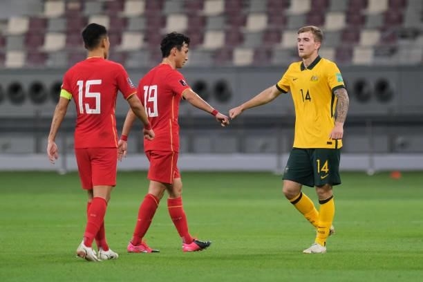 Riley McGree of Australia and Yin Hongbo of China after Australia v China PR - 2022 FIFA World Cup Qualifier at Khalifa International Stadium on...
