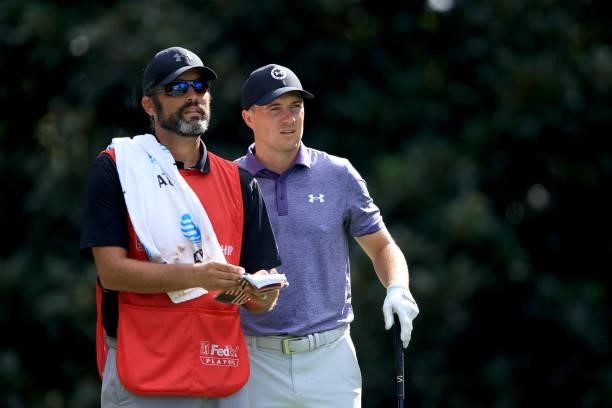 Jordan Spieth talks with his caddie Michael Greller on the 17th hole during the first round of the TOUR Championship at East Lake Golf Club on...