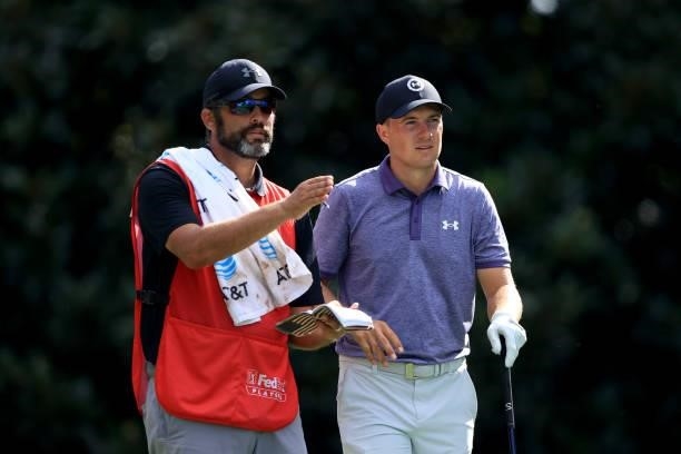 Jordan Spieth talks with his caddie Michael Greller on the 17th hole during the first round of the TOUR Championship at East Lake Golf Club on...