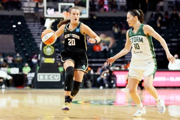 Sabrina Ionescu of the New York Liberty dribbles against Sue Bird of the Seattle Storm during the third quarter at Angel of the Winds Arena on...