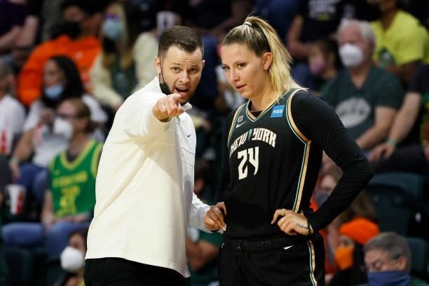 Head coach Walt Hopkins of New York Liberty talks with Kylee Shook during the third quarter against the Seattle Storm at Angel of the Winds Arena on...