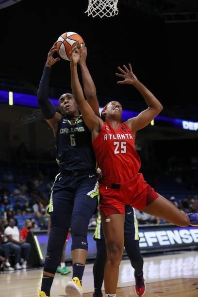 Forward Kayla Thornton of the Dallas Wings rebounds the ball against forward Monique Billings of the Atlanta Dream in the first half at College Park...